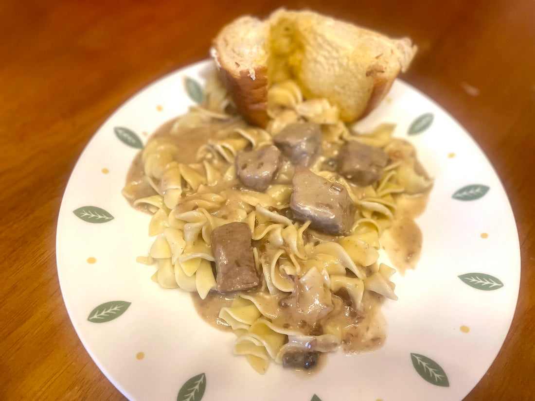 Beef stroganoff served over egg noodles