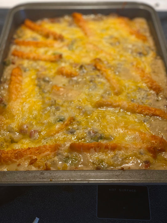 Cowboy casserole topped with tator tots and cheese