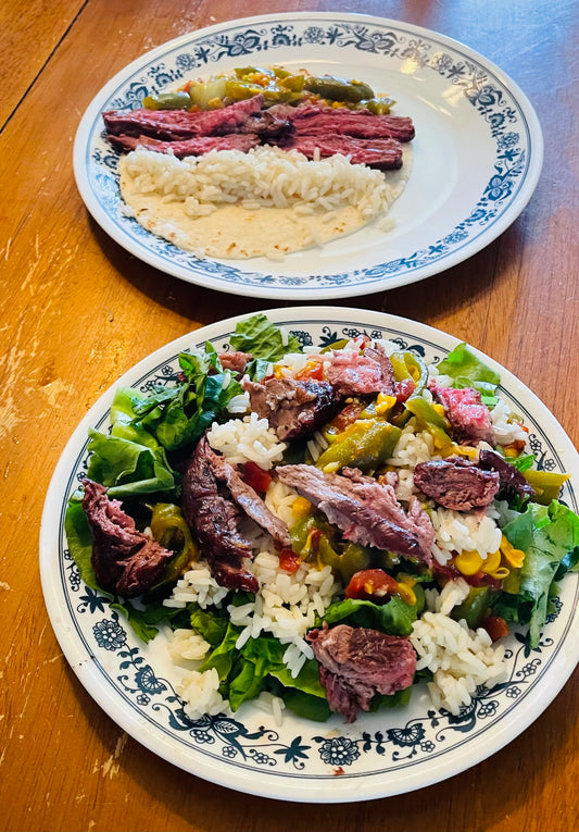 Burrito bowl with skirt steak, rice, and vegetables